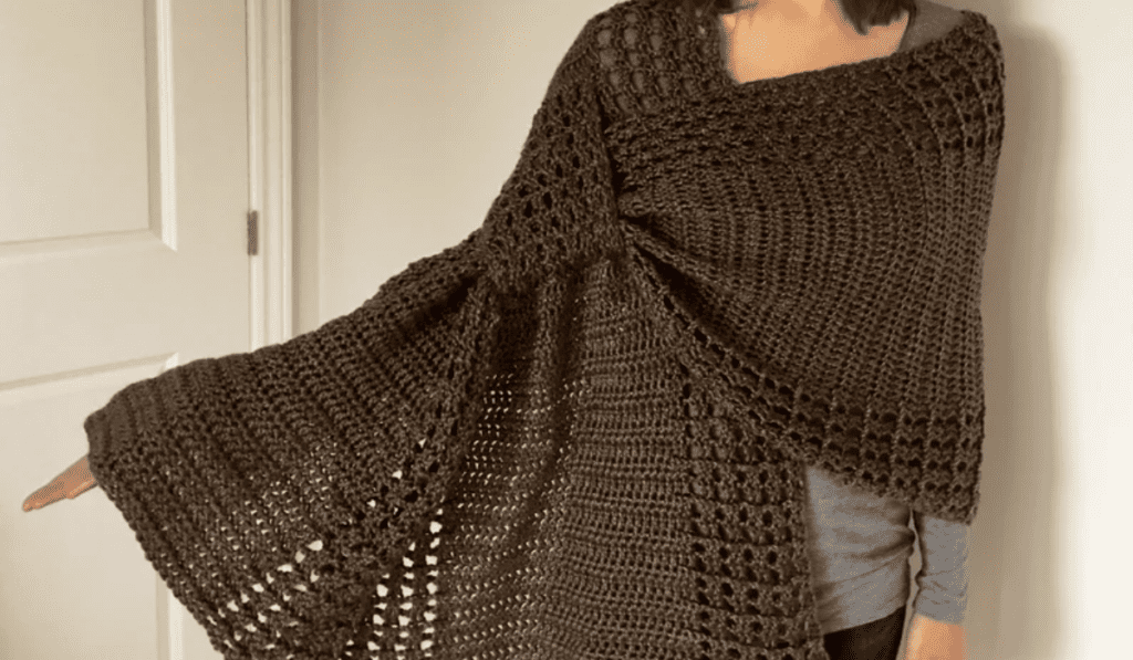 A large brown shawl drapped across someone's body.