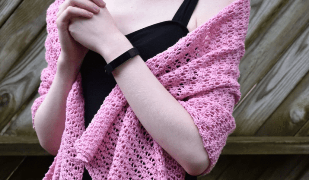Pink shawl drapped around someone's shoulders.