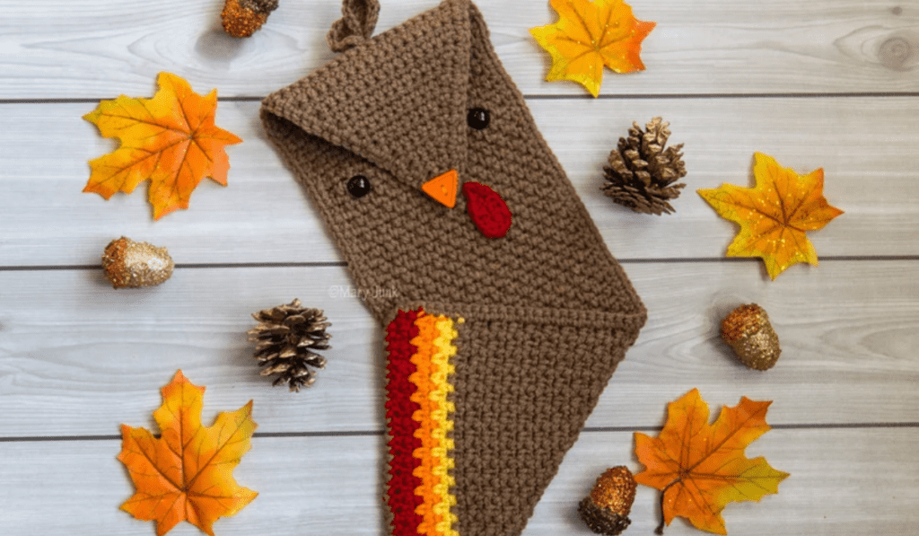 A crochet turkey towel with a button beak closure.