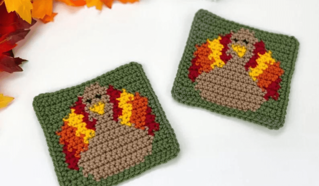 Square turkey coasters with green yarn backdrop.