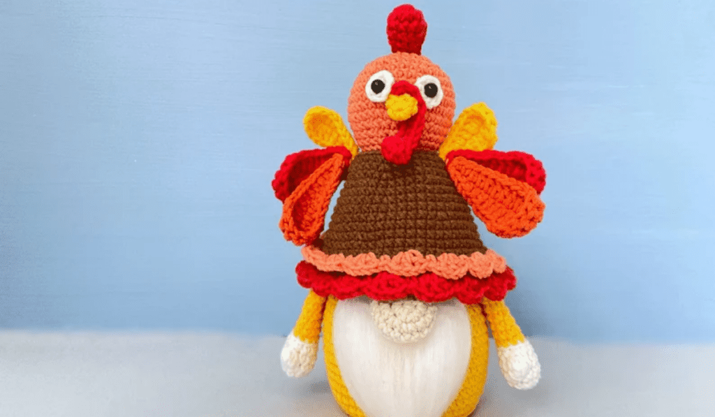 A gnome wearing a crochet turkey hat