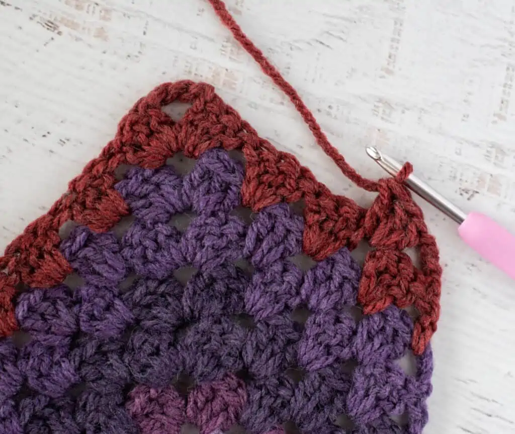 Purple and burgundy Crochet afghan step by step photo with pink crochet hook