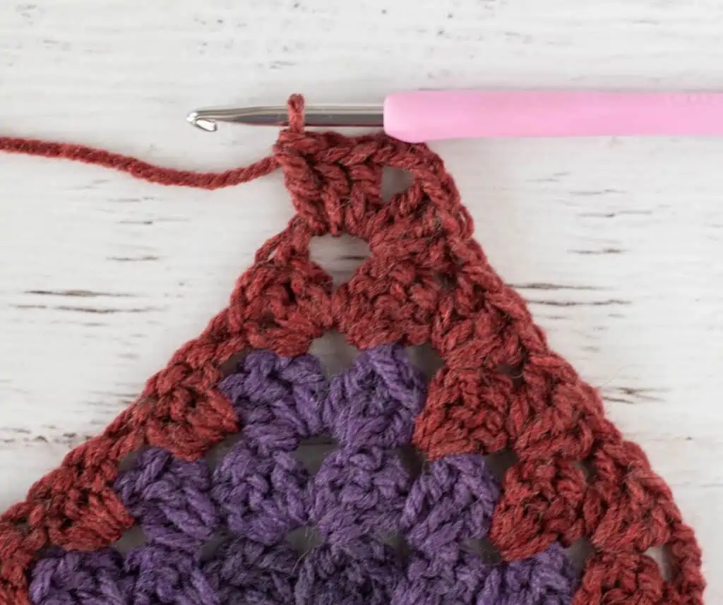 Purple and burgundy Crochet afghan step by step photo with pink crochet hook