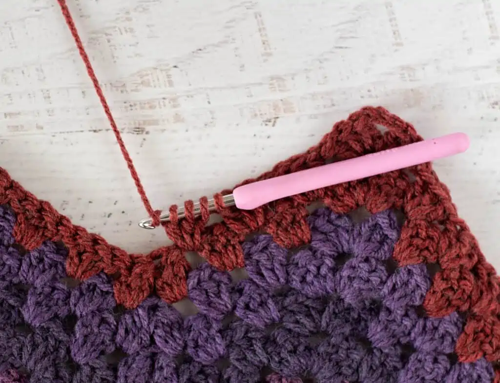 Purple and burgundy Crochet afghan step by step photo with pink crochet hook