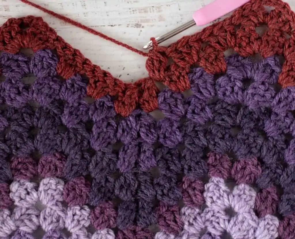 Purple and burgundy Crochet afghan step by step photo with pink crochet hook