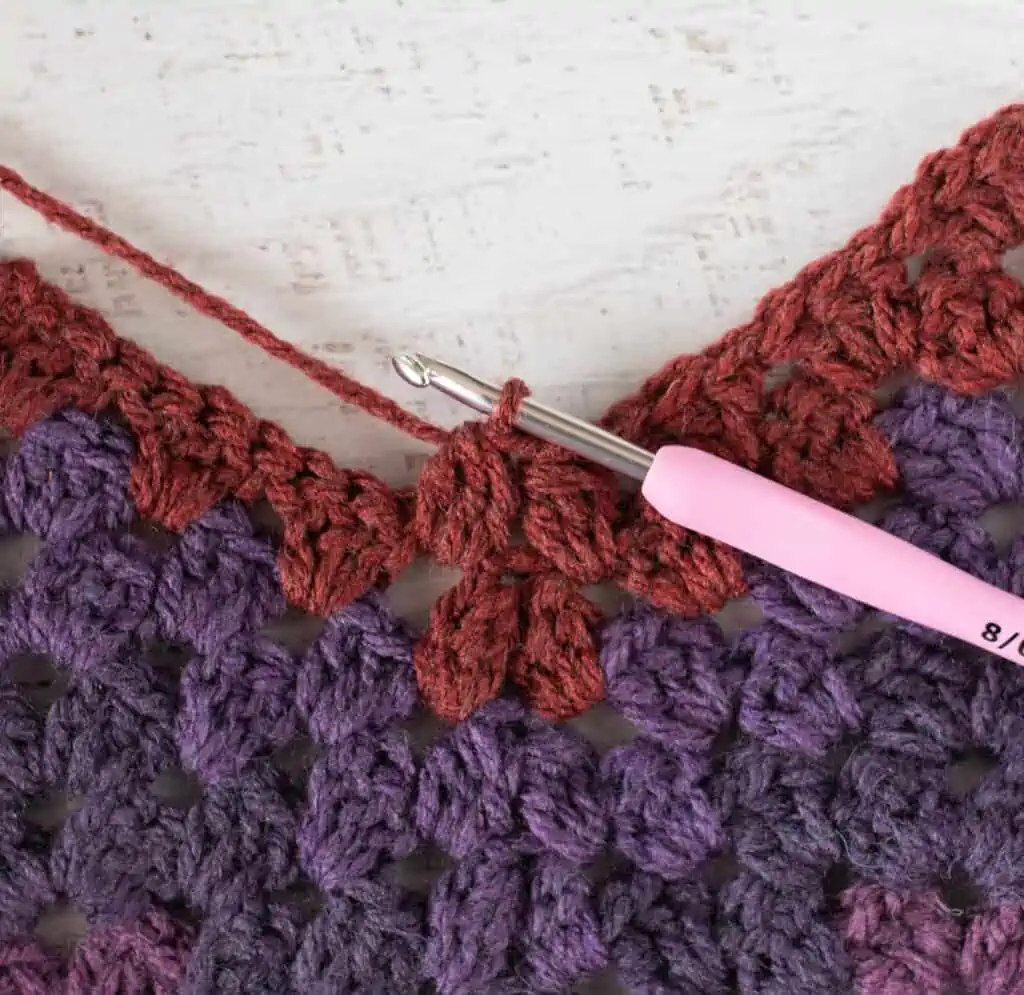 Purple and burgundy Crochet afghan step by step photo with pink crochet hook