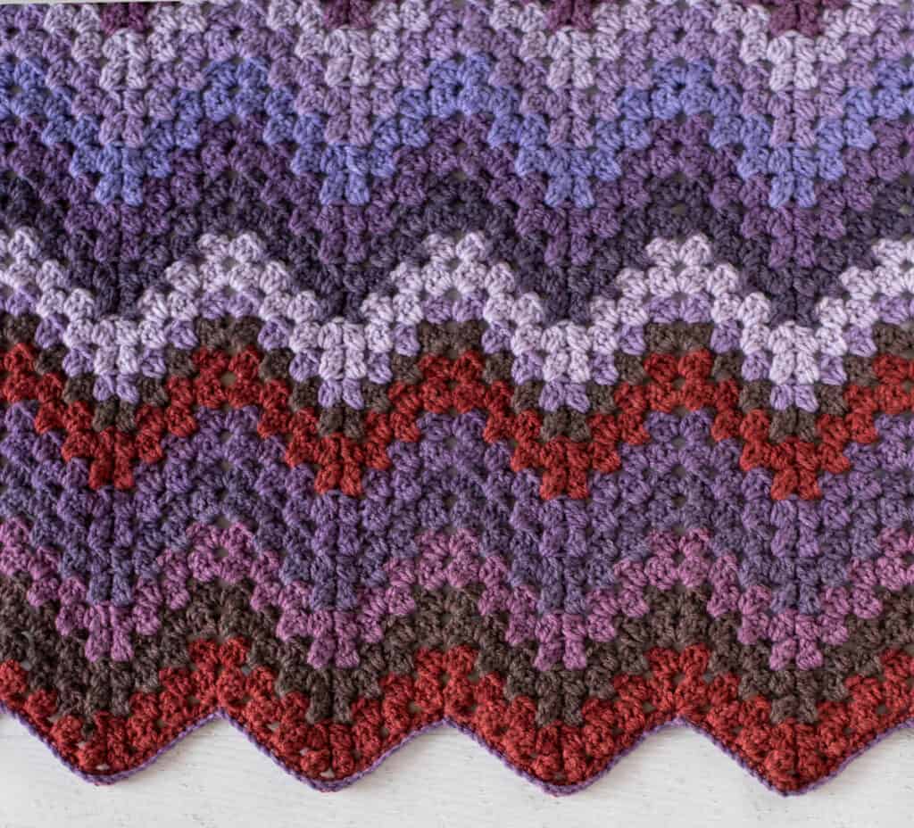 Crochet chevron afghan in shades of purple and burgundy