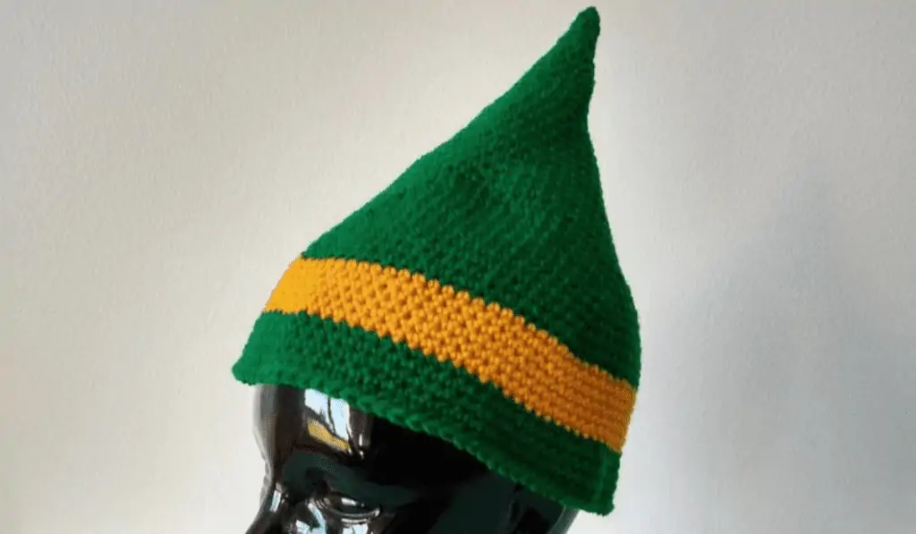 A elf hat that look like an acorn with a gold band.