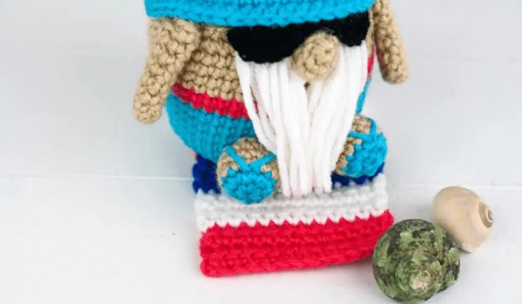 crochet summertime gnome with beach towel, flip flops, sunglasses, and sea shells