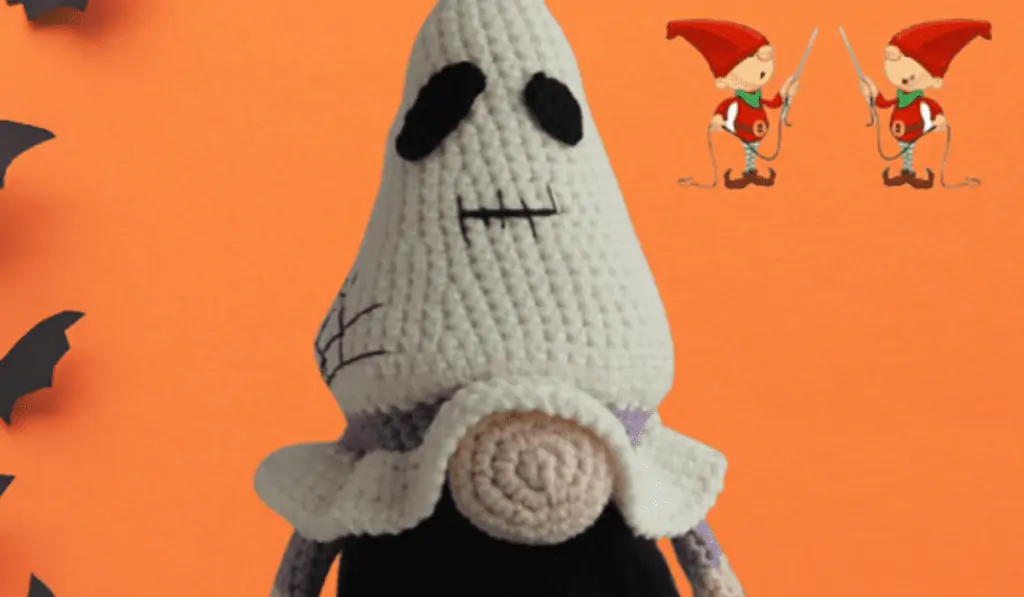 crochet halloween ghost gnome with pumpkin in background