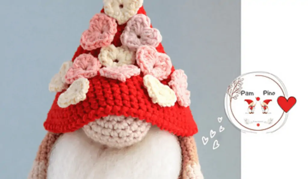 Red, white and pink heart themed crochet gnome.