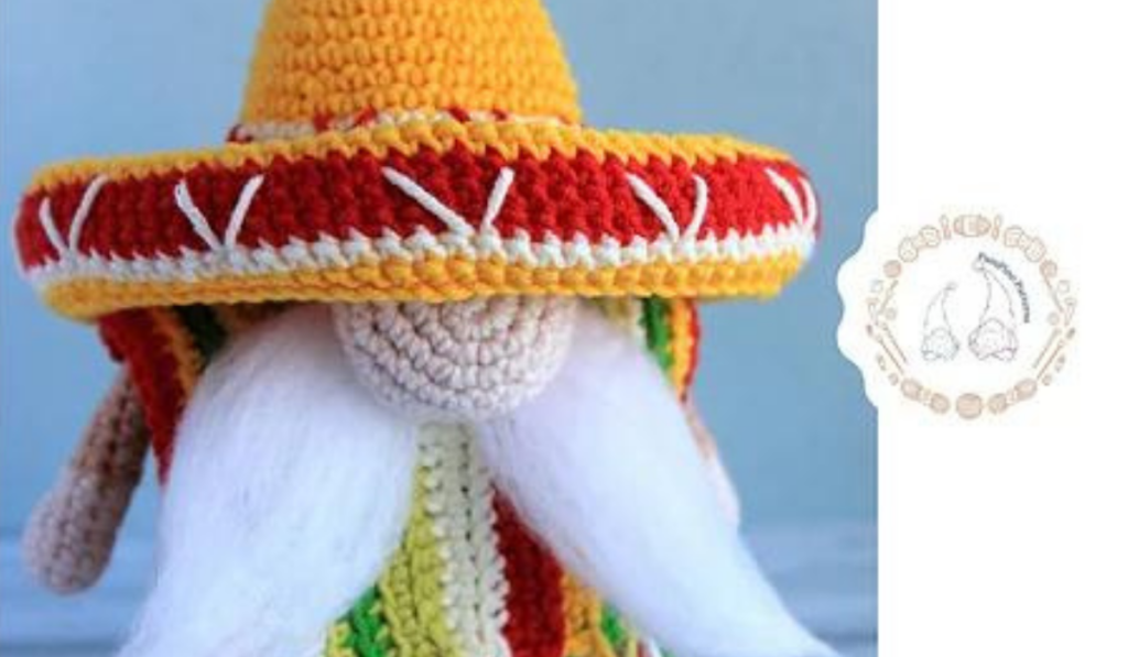 crochet gnome with a sombero and pancho.