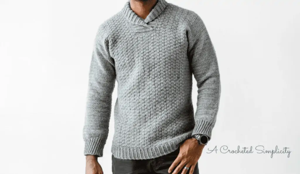 A grey crochet pullover sweater.