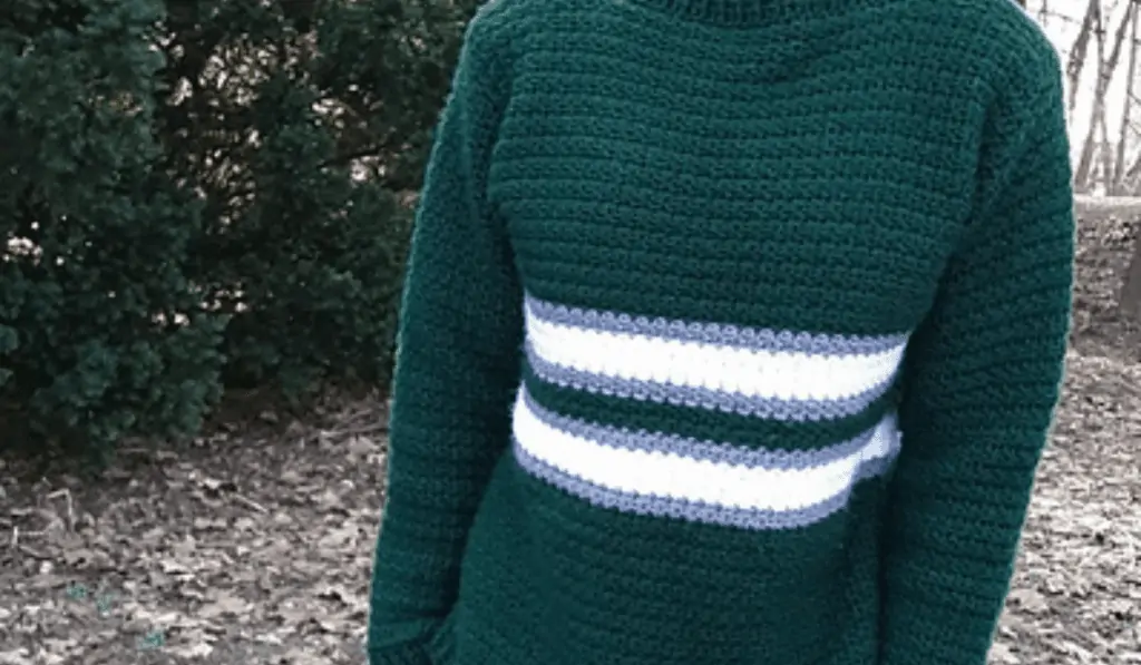 A green crochet sweater with stripes.