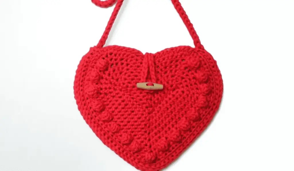 A red crochet heart-shaped bag.