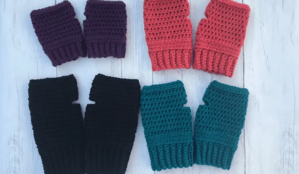 Four pairs of crochet gloves in different sizes and different colors, including purple, pink, black, and blue.