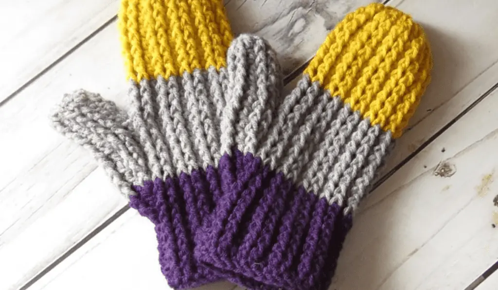 Crochet mittens with three large stripes of color, yellow, grey, and purple.