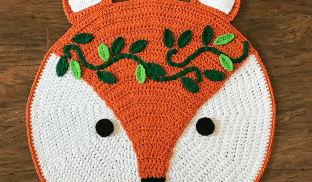 A circle crochet rug that looks like a fox.