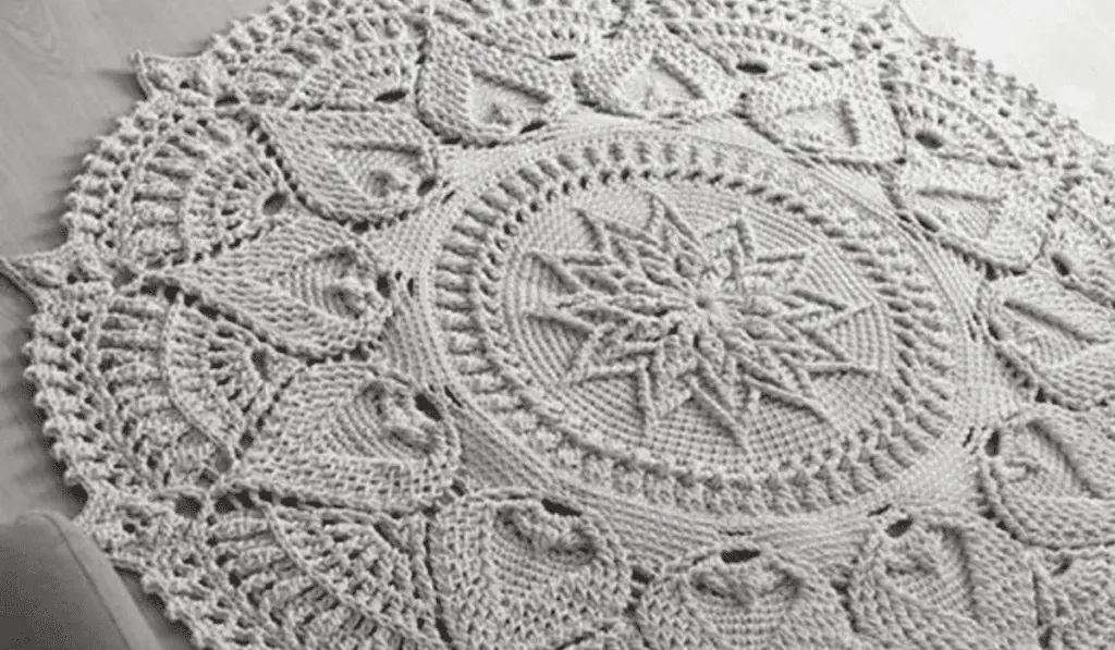 An off-white crochet mandala rug.