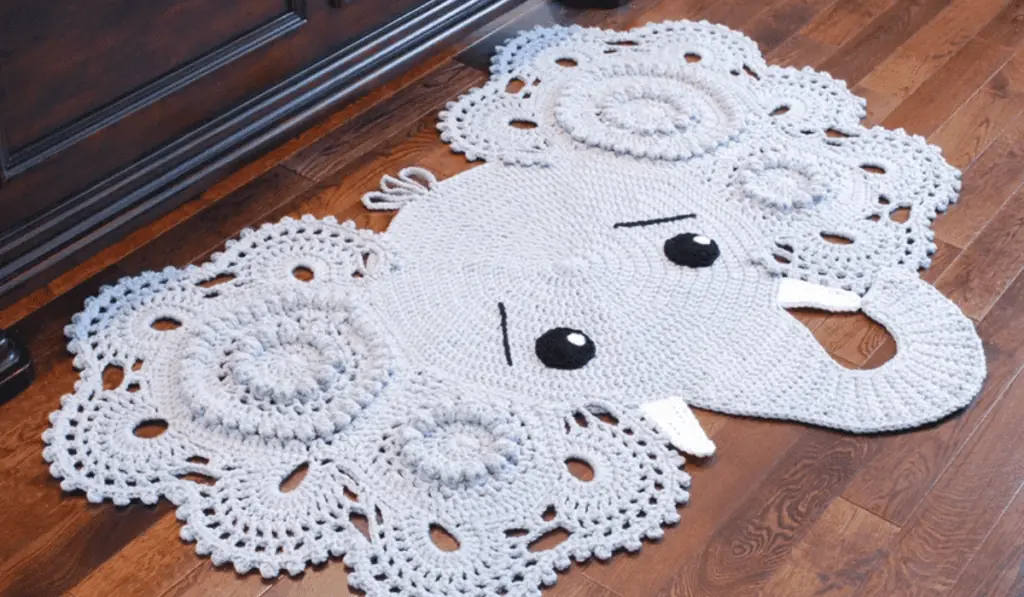 A crochet elephant rug with swirl patterns to make up the ears.