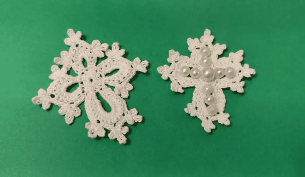 Lacy white crochet crosses, one that has pearls to make a small ross on it.