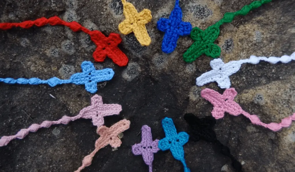 Eleven different colored crochet rosaries.