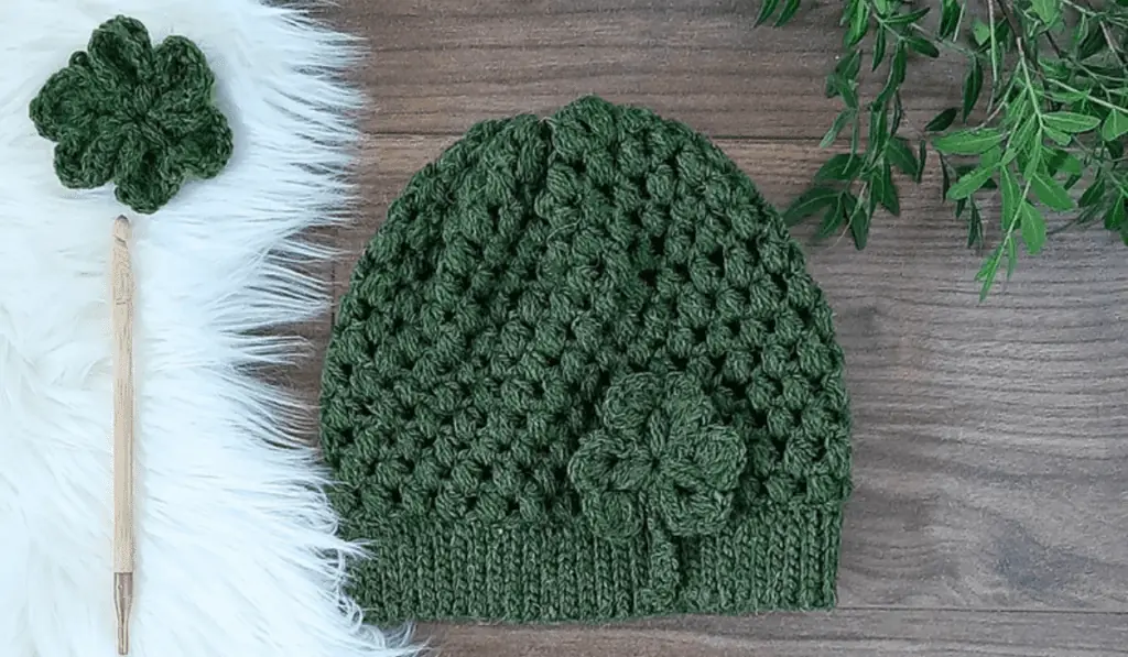A crochet beanie with a shamrock applique.