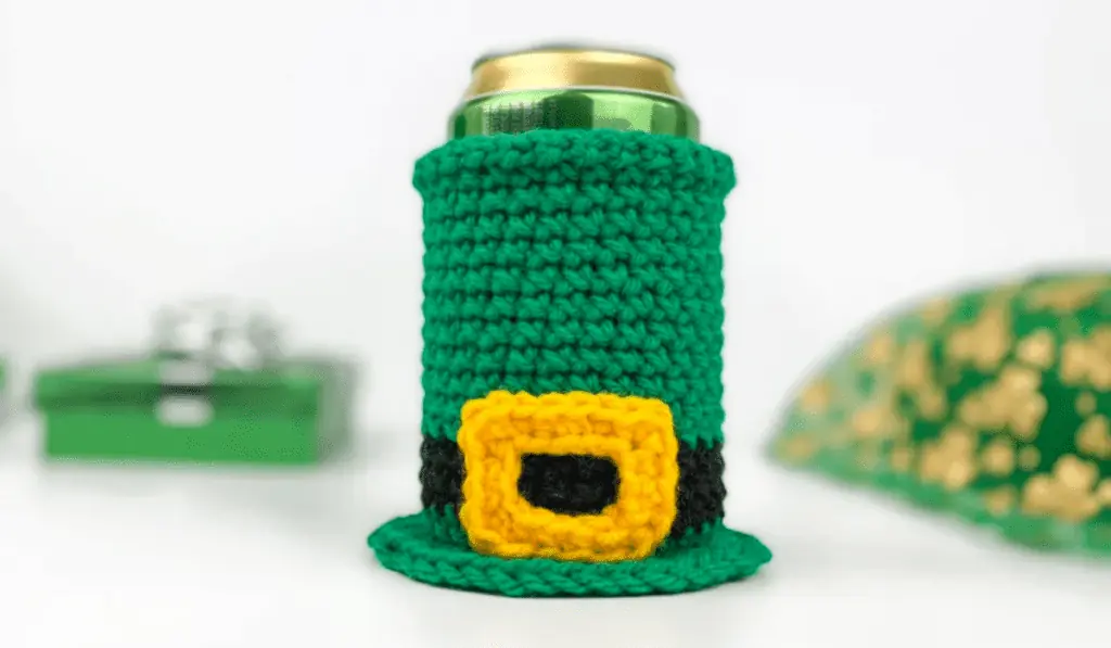 A crocheted can cozy that looks like a leprechaun hat