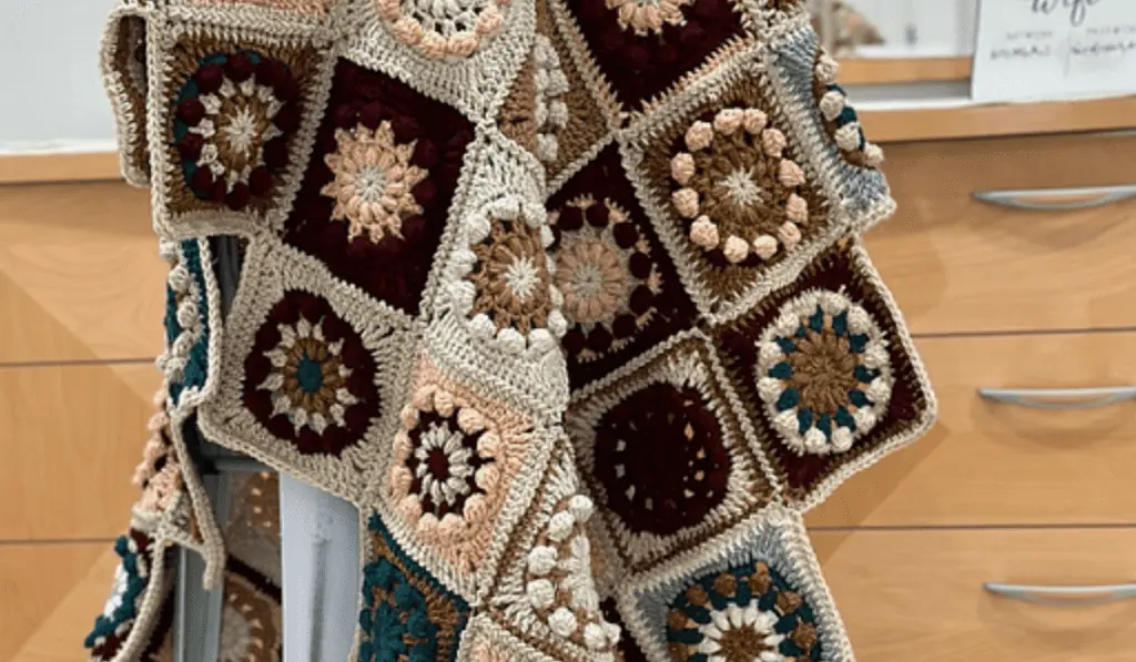 An afghan with flower squares.