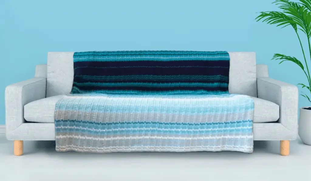 A blanket made out of different shades of blue.