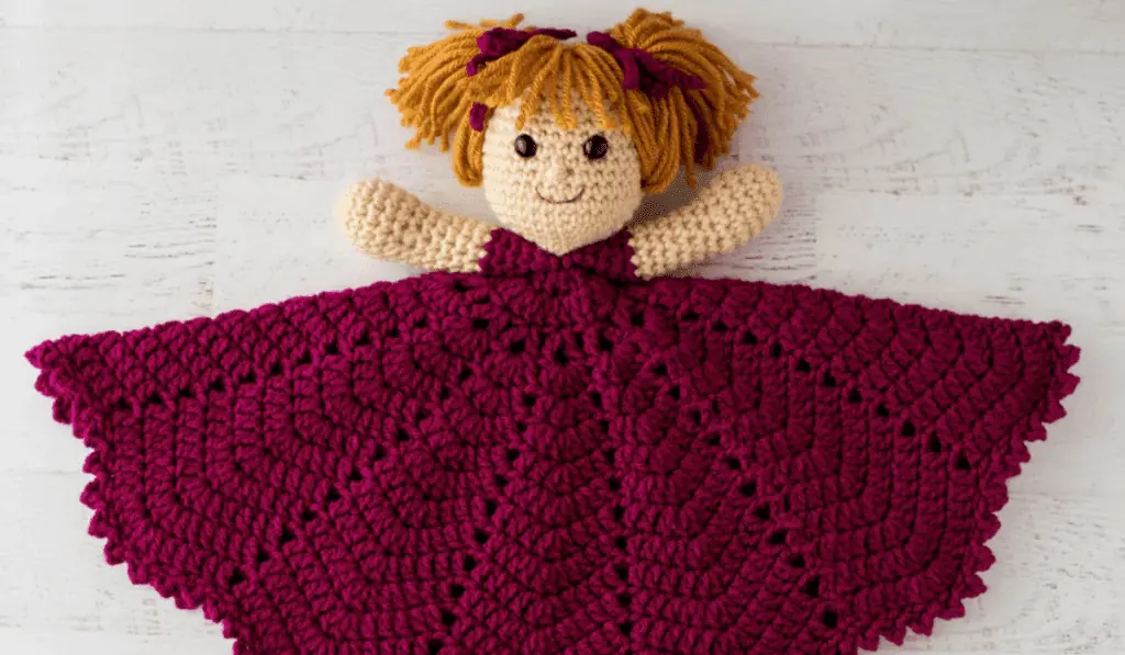 A crochet lovey with pigtails and the blanket part makes up the dress.