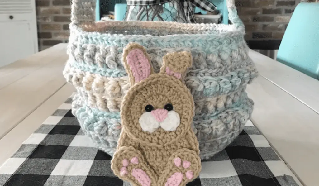 A crochet Easter basket with a bunny motif on the front