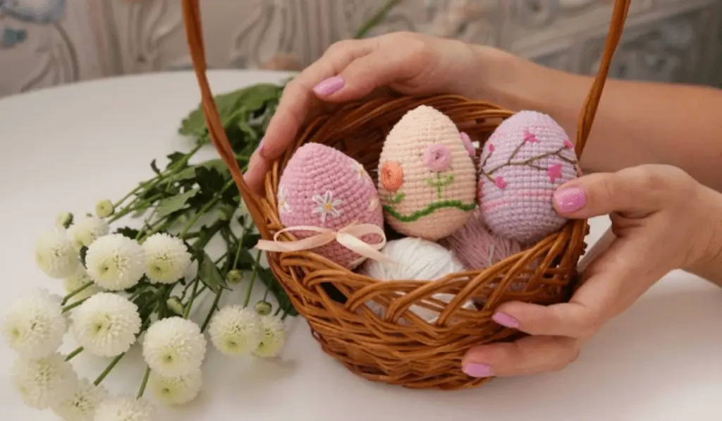Crochet eggs with different embroidered patterns on the eggs.