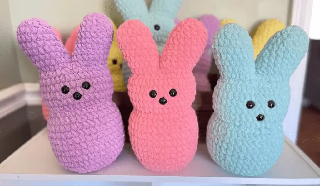 Crochet Easter bunnies that look like giant marshmallows in multiple colors, including purple, pink, blue, and yellow.