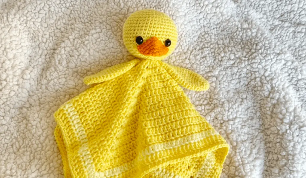 A crochet duck lovey