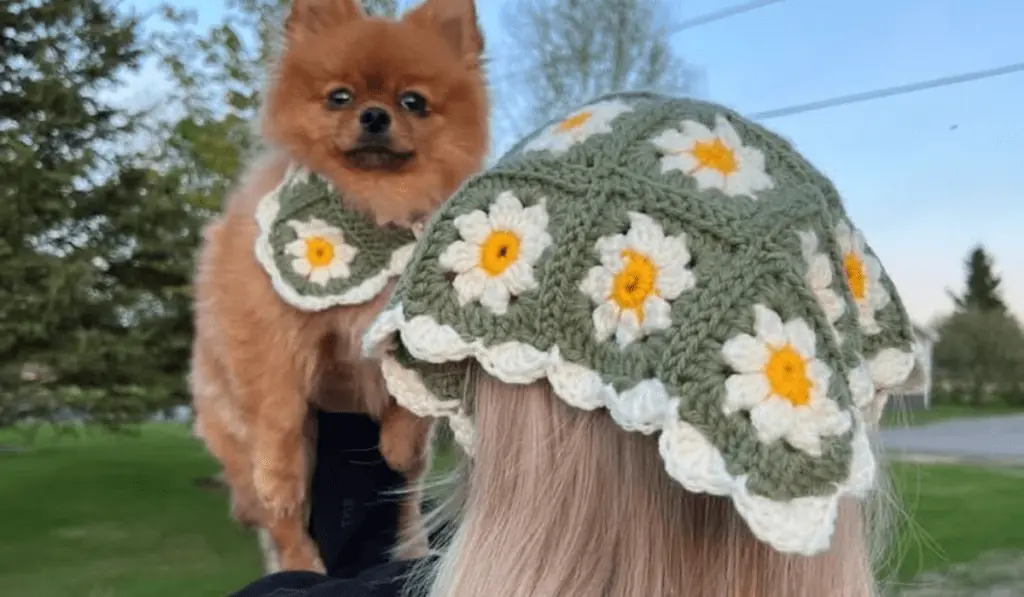 Matching crochet bandanas for a woman and her dog.
