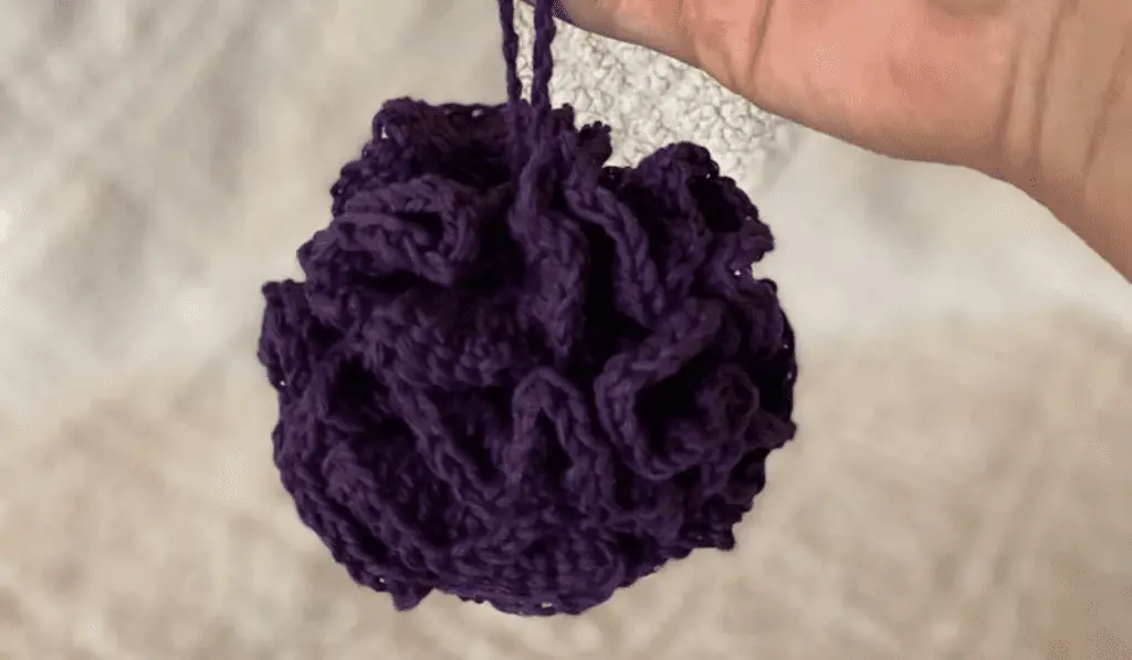 a purple crochet loofah