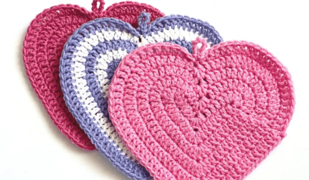 Three heart-shaped crochet potholders