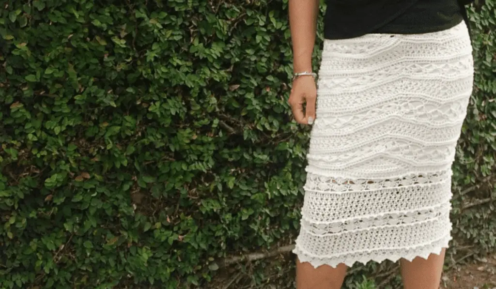 A lacy crochet skirt with an underslip that is knee-length.