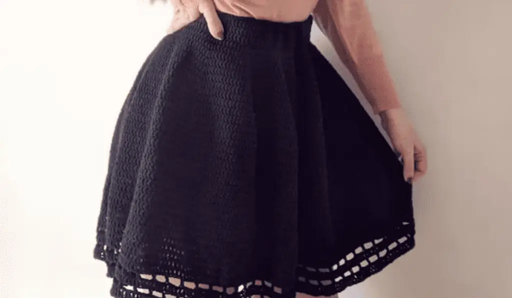 An all black circular skirt with cut-outs at the bottom