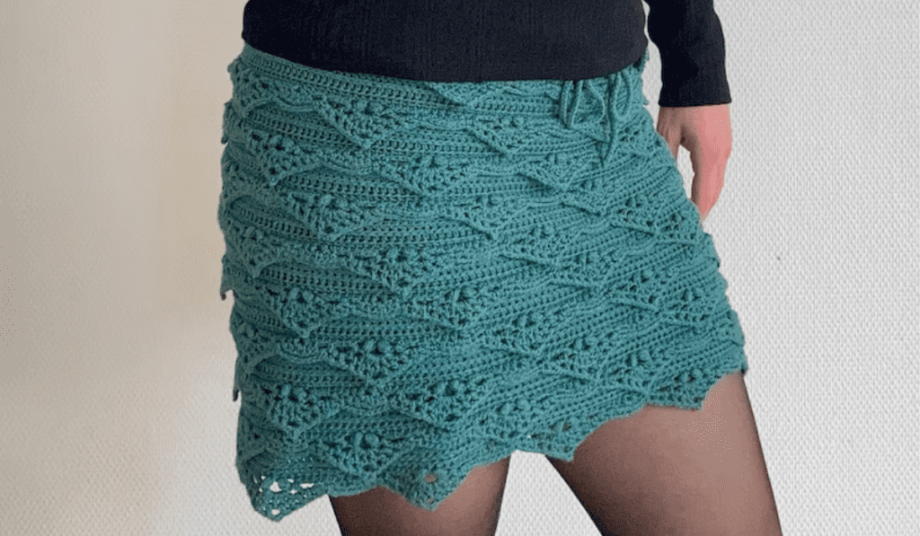 A blue crochet mini skirt with little triangle ruffles.