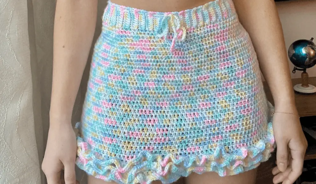 A pastel crochet skirt with ruffles along the bottom