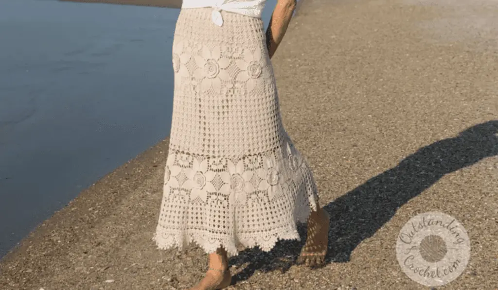 An ankle-length lacy crochet skirt with flower designs.