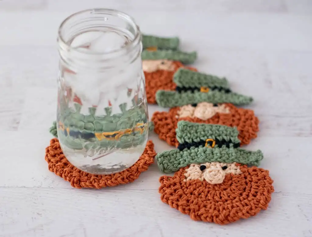 St Patricks Day Crochet Coasters, 4 leprechaun crochet coasters with a glass of water