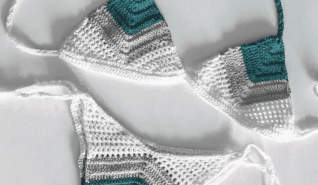 A blue, grey, and white crochet bikini.