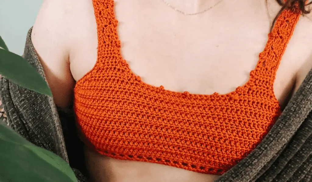 An orange crochet bikini top with a straight across style top.