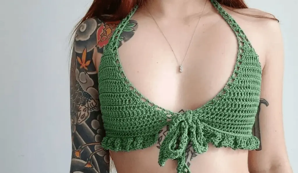 A green crochet bikini top with ruffles along the bottom.