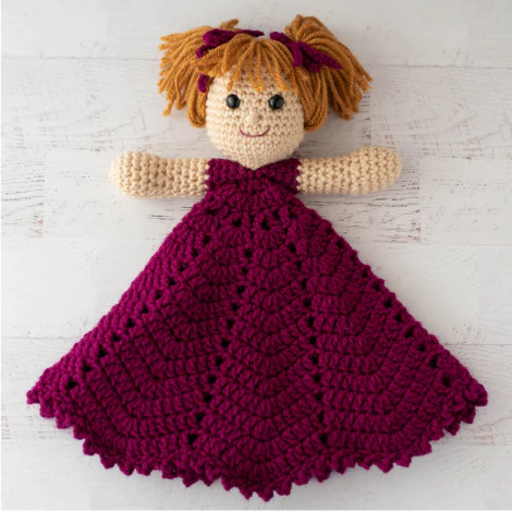 crochet princess lovey with gold hair and bright pink dress