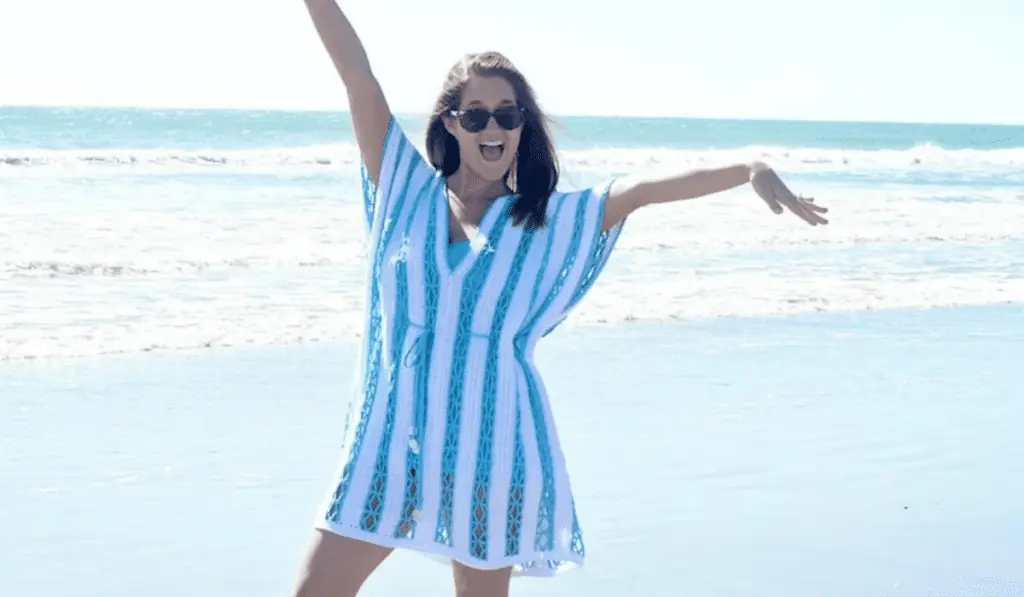A short crochet beach cover-up with blue and white stripes