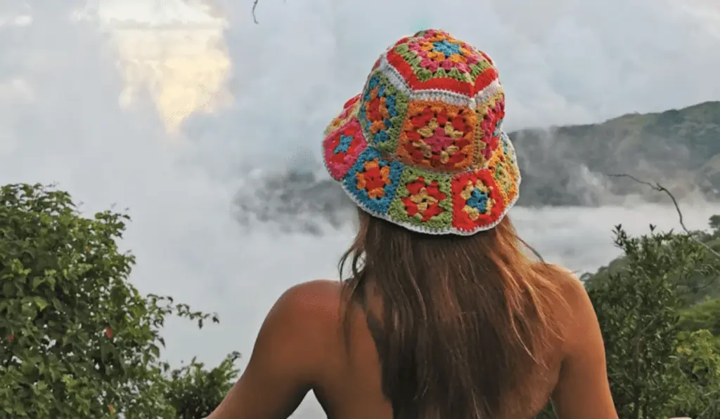 A granny square crochet bucket hat with bright colors such as blue, red, orange, yellow, and green.